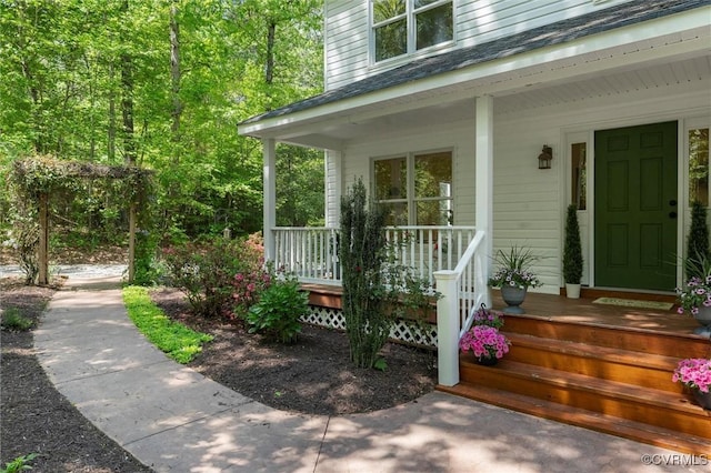 view of exterior entry with a porch