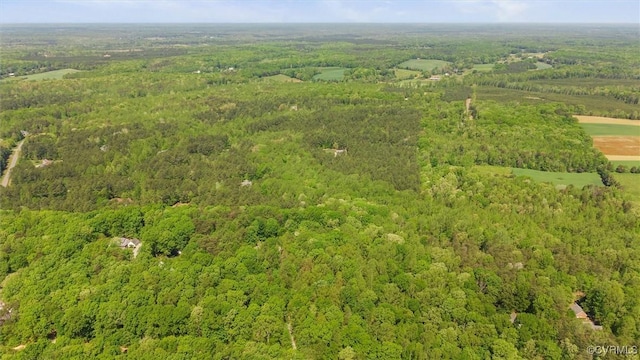 drone / aerial view with a wooded view