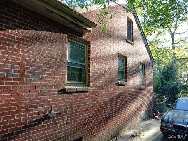 view of side of property featuring brick siding