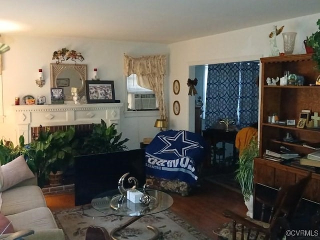 living area featuring wood finished floors and cooling unit