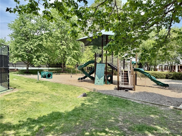 communal playground with fence and a yard