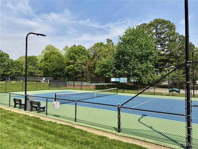view of sport court featuring a lawn and fence
