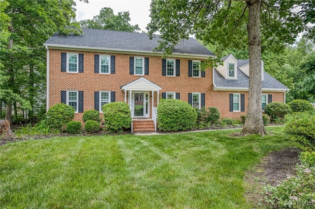 12911 Chipstead Rd, Chester, VA 23831 - colonial-style house with brick siding, a front lawn, and a shingled roof