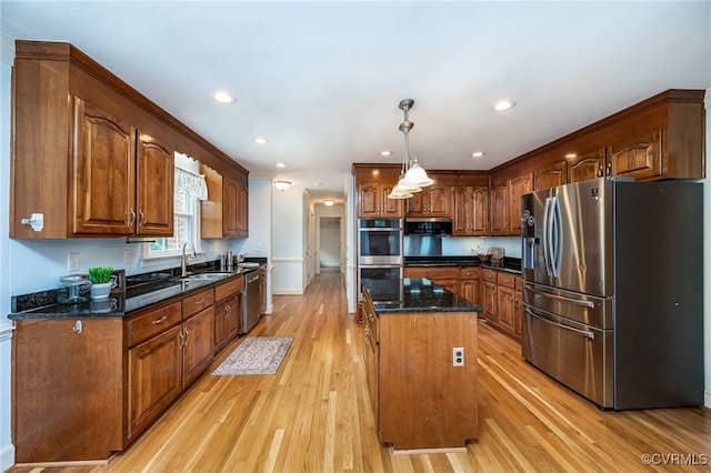12911 Chipstead Rd, Chester, VA 23831 - kitchen featuring stainless steel appliances, a sink, light wood finished floors, a center island, and dark stone countertops