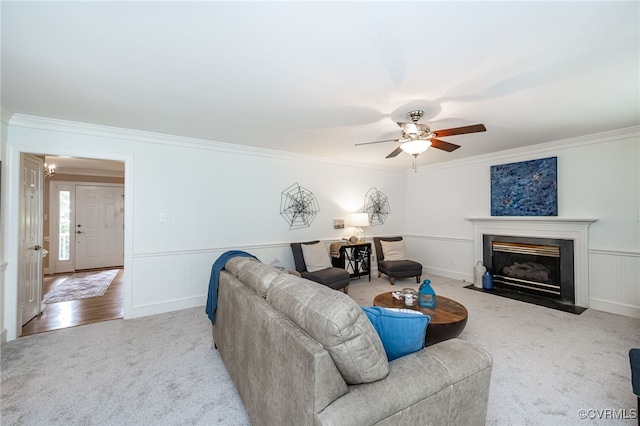 12911 Chipstead Rd, Chester, VA 23831 - living room featuring carpet, ornamental molding, a ceiling fan, wainscoting, and a fireplace with flush hearth