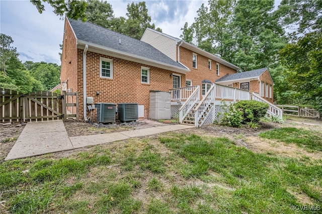 12911 Chipstead Rd, Chester, VA 23831 - back of house featuring a gate, brick siding, a deck, stairway, and roof with shingles