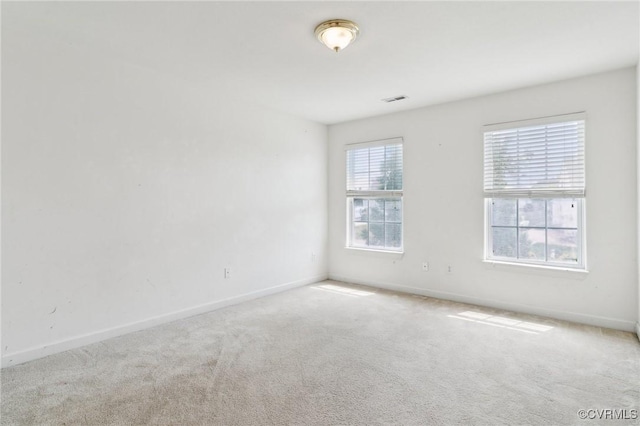 unfurnished room with visible vents, carpet flooring, and baseboards