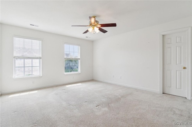 spare room with visible vents, baseboards, ceiling fan, and carpet floors
