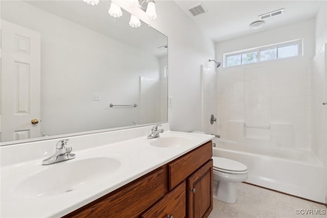bathroom with a sink, toilet, and visible vents