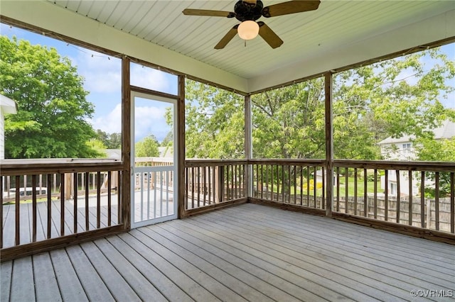 unfurnished sunroom with plenty of natural light and ceiling fan