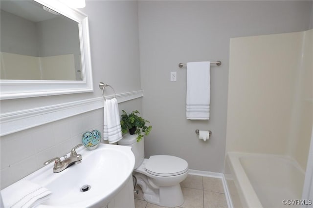 bathroom featuring a sink, walk in shower, a tub, toilet, and tile patterned flooring