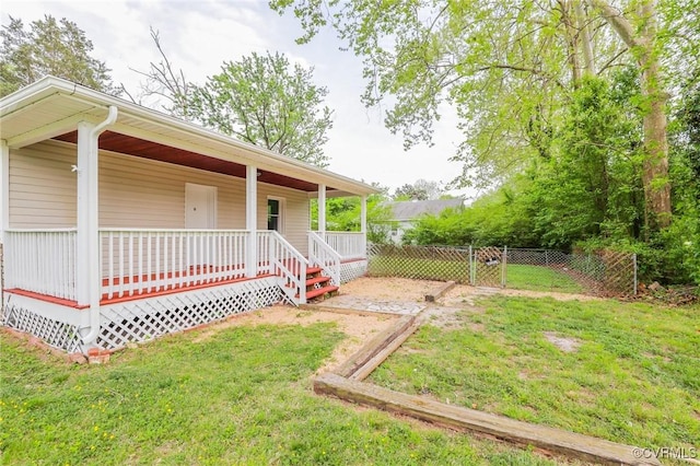 exterior space featuring a yard, covered porch, and fence