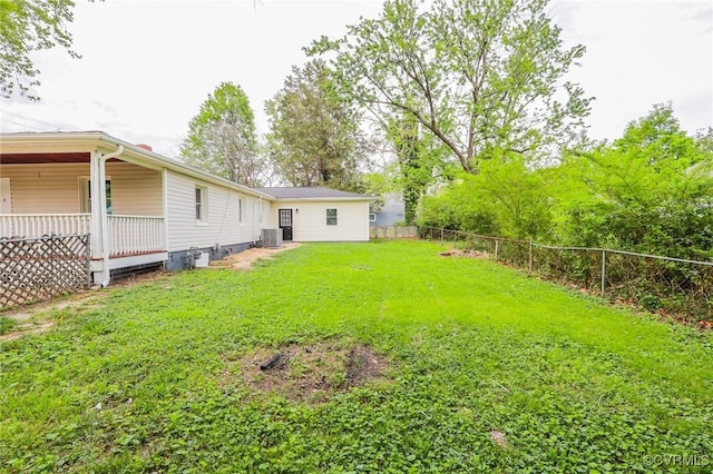 view of yard featuring a fenced backyard and central AC