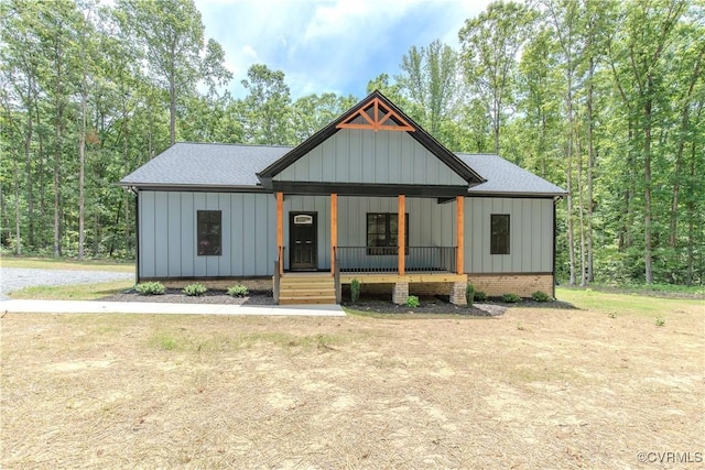 modern farmhouse style home with a porch and board and batten siding