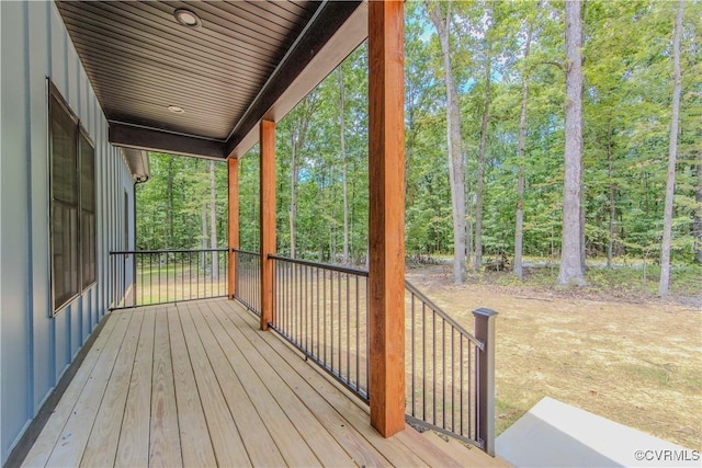 wooden deck with a view of trees
