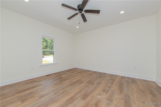 unfurnished room with recessed lighting, light wood-type flooring, a ceiling fan, and baseboards
