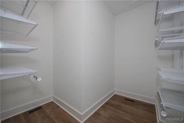 walk in closet featuring wood finished floors and visible vents