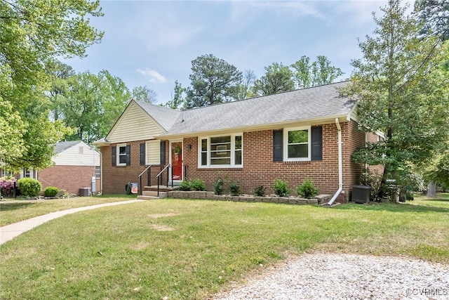 single story home with brick siding, a shingled roof, a front lawn, and cooling unit