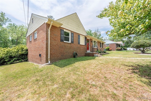 view of front of property with brick siding and a front lawn