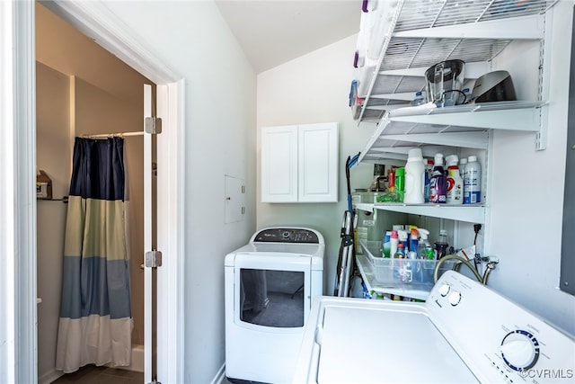 laundry area featuring washing machine and clothes dryer and cabinet space