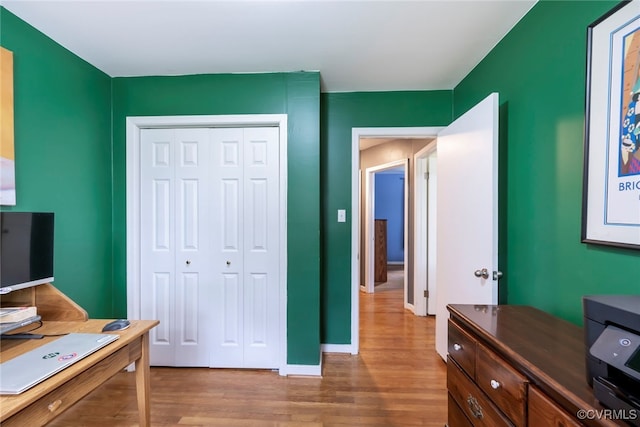 office area with baseboards and wood finished floors