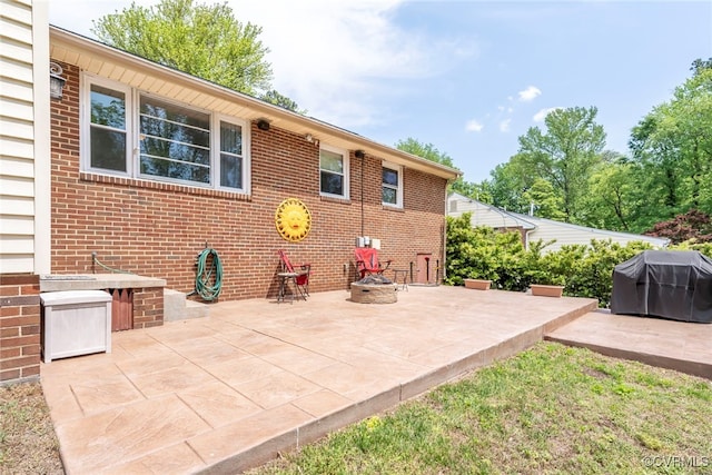 view of patio / terrace featuring a grill and an outdoor fire pit