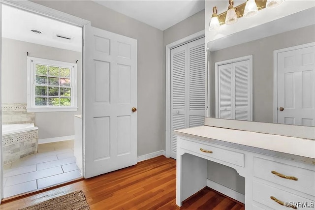 331 Harwick, North Chesterfield, VA 23236 - bathroom with a closet, wood finished floors, a garden tub, and baseboards