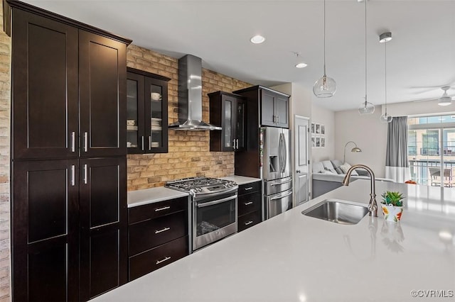 10925 Parkshire Ln, Henrico, VA 23233 - kitchen with stainless steel appliances, wall chimney exhaust hood, a sink, light countertops, and glass insert cabinets