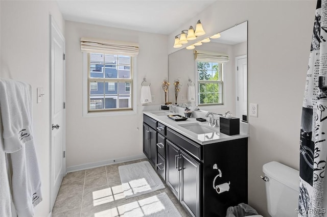 10925 Parkshire Ln, Henrico, VA 23233 - bathroom with baseboards, double vanity, and toilet