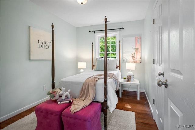 bedroom with baseboards and wood finished floors