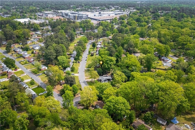 drone / aerial view featuring a wooded view