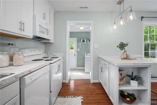 kitchen featuring dark wood-style flooring, open shelves, white appliances, washer / clothes dryer, and visible vents