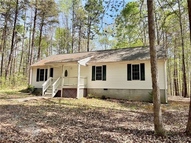 view of front of house featuring roof with shingles, crawl space, and covered porch