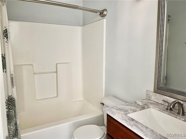 bathroom featuring toilet, vanity, and tub / shower combination