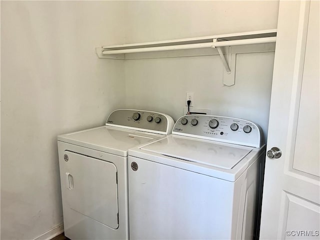 washroom featuring washing machine and clothes dryer and laundry area