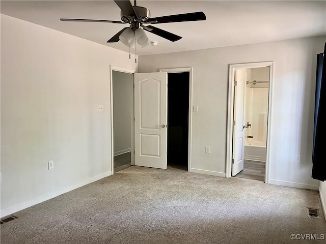unfurnished bedroom featuring carpet, visible vents, baseboards, ceiling fan, and ensuite bathroom