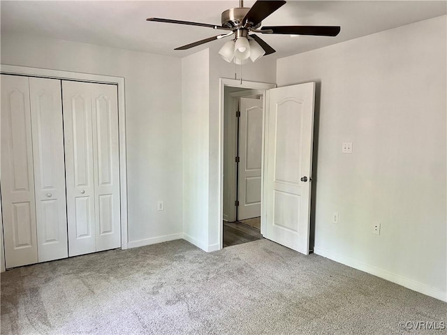 unfurnished bedroom featuring a ceiling fan, carpet floors, a closet, and baseboards
