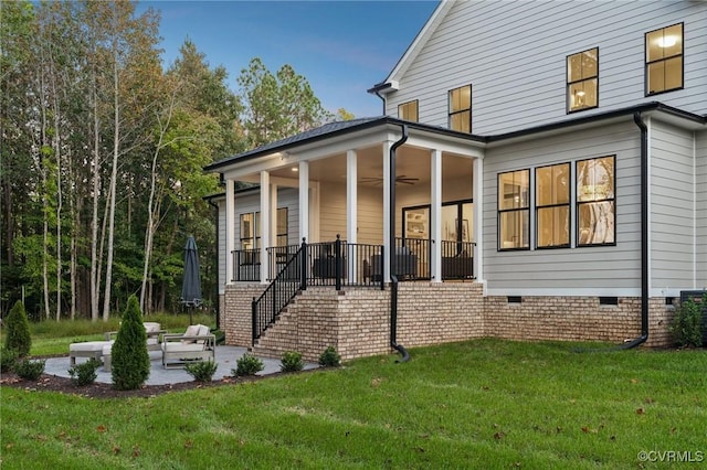 rear view of house featuring stairway, a yard, crawl space, a patio area, and ceiling fan