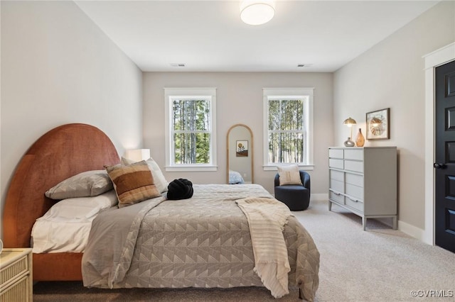 bedroom featuring visible vents, carpet flooring, and baseboards