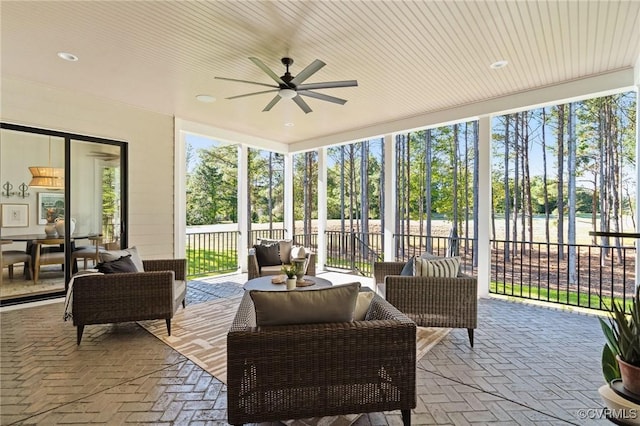 sunroom / solarium featuring brick floor