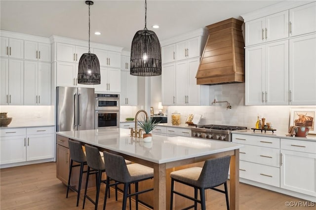 kitchen with backsplash, white cabinetry, custom exhaust hood, and stainless steel appliances