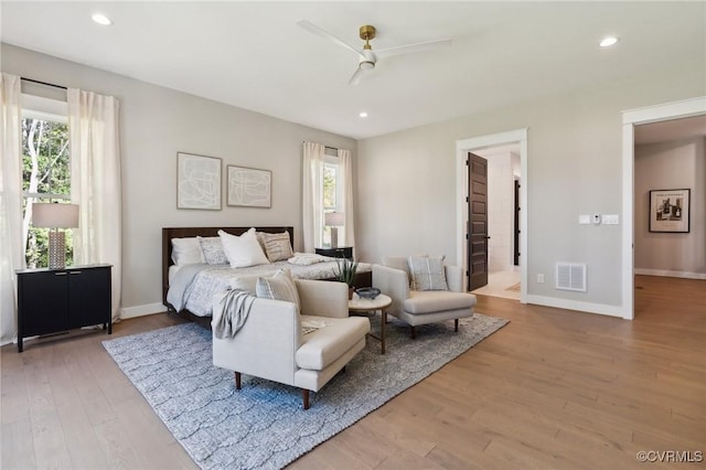 bedroom with recessed lighting, wood finished floors, visible vents, and baseboards