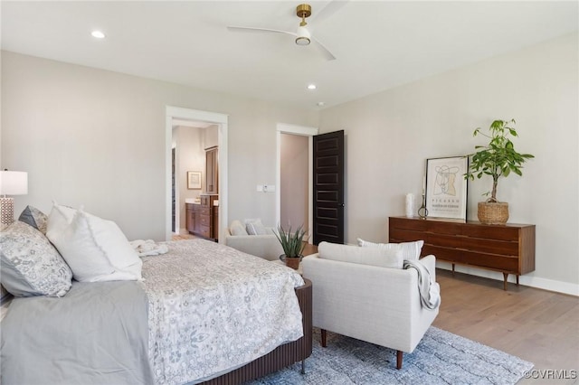bedroom with recessed lighting, wood finished floors, ensuite bath, and ceiling fan