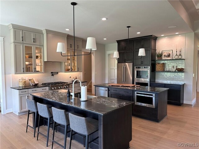 0 Three Chopt Rd, Gum Spring, VA 23065 - kitchen with a center island with sink, stainless steel appliances, a sink, backsplash, and light wood-style flooring