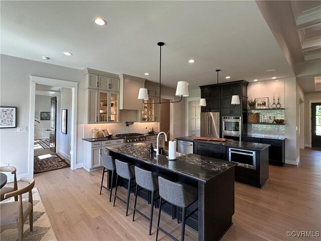 0 Three Chopt Rd, Gum Spring, VA 23065 - kitchen featuring an island with sink, stainless steel appliances, backsplash, a sink, and a breakfast bar area