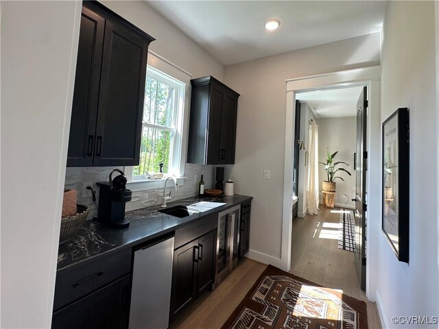 0 Three Chopt Rd, Gum Spring, VA 23065 - kitchen with dark countertops, a sink, dark cabinetry, wood finished floors, and tasteful backsplash