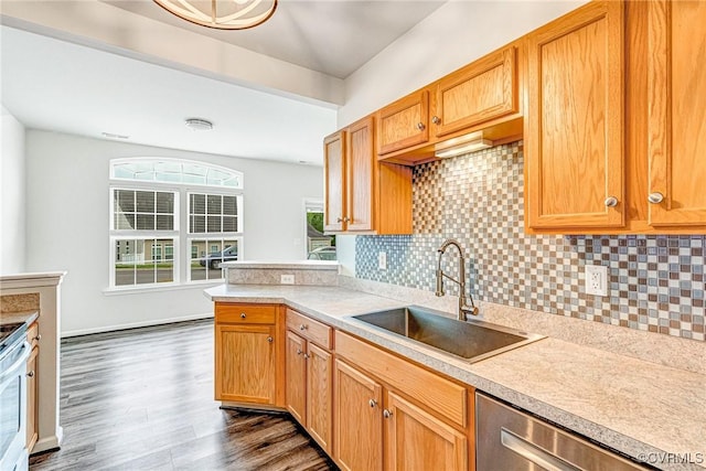 kitchen featuring tasteful backsplash, a sink, dishwasher, light countertops, and dark wood-type flooring