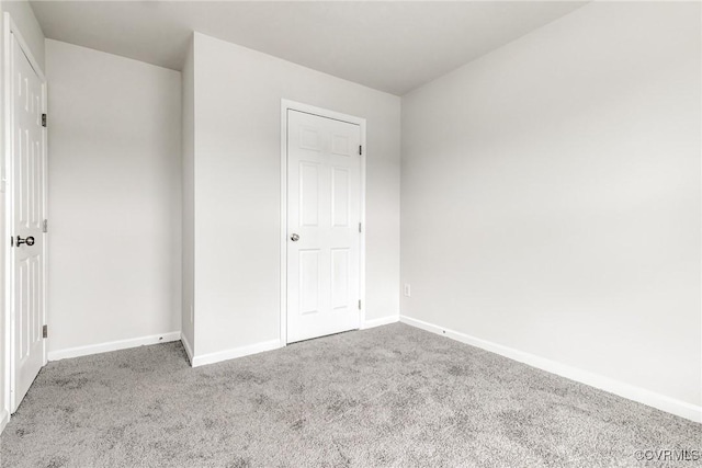 unfurnished bedroom featuring baseboards and carpet flooring