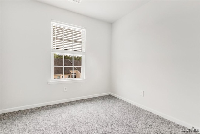 carpeted empty room with baseboards