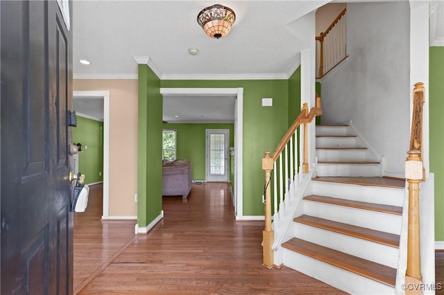 entrance foyer with stairway, baseboards, and wood finished floors